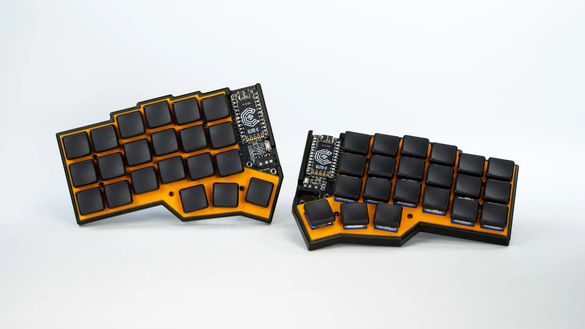 Small, split keyboard with a yellow bottom and blank black keys.