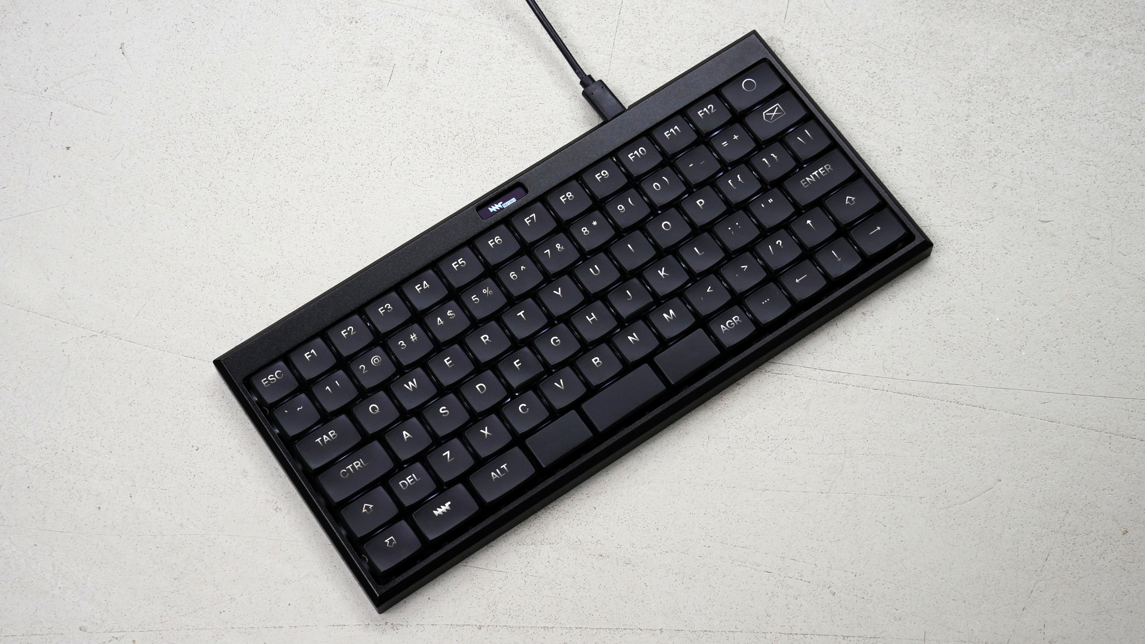 Small black keyboard with a small OLED display