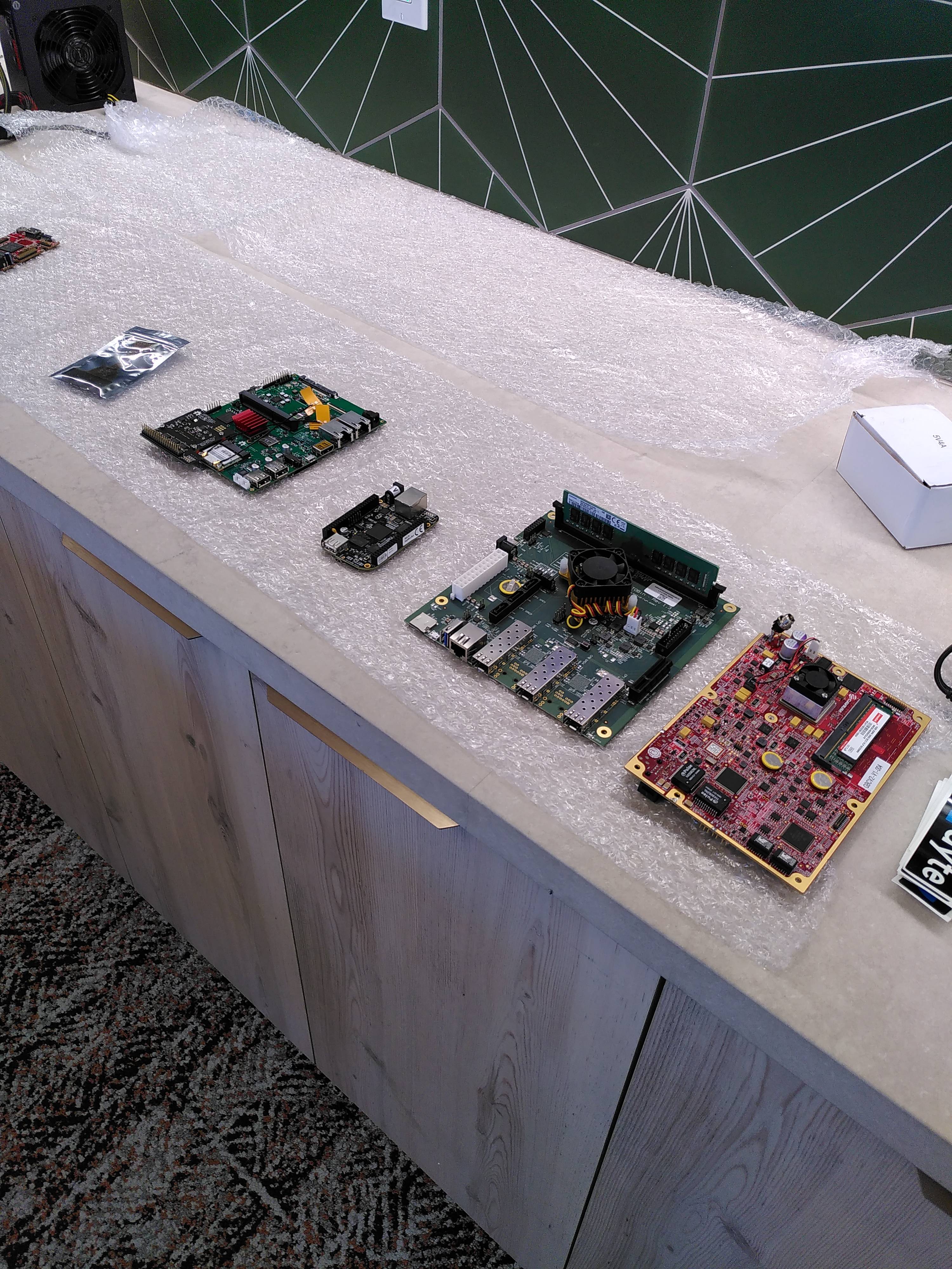 Table with dev boards of different sizes lying on parade.