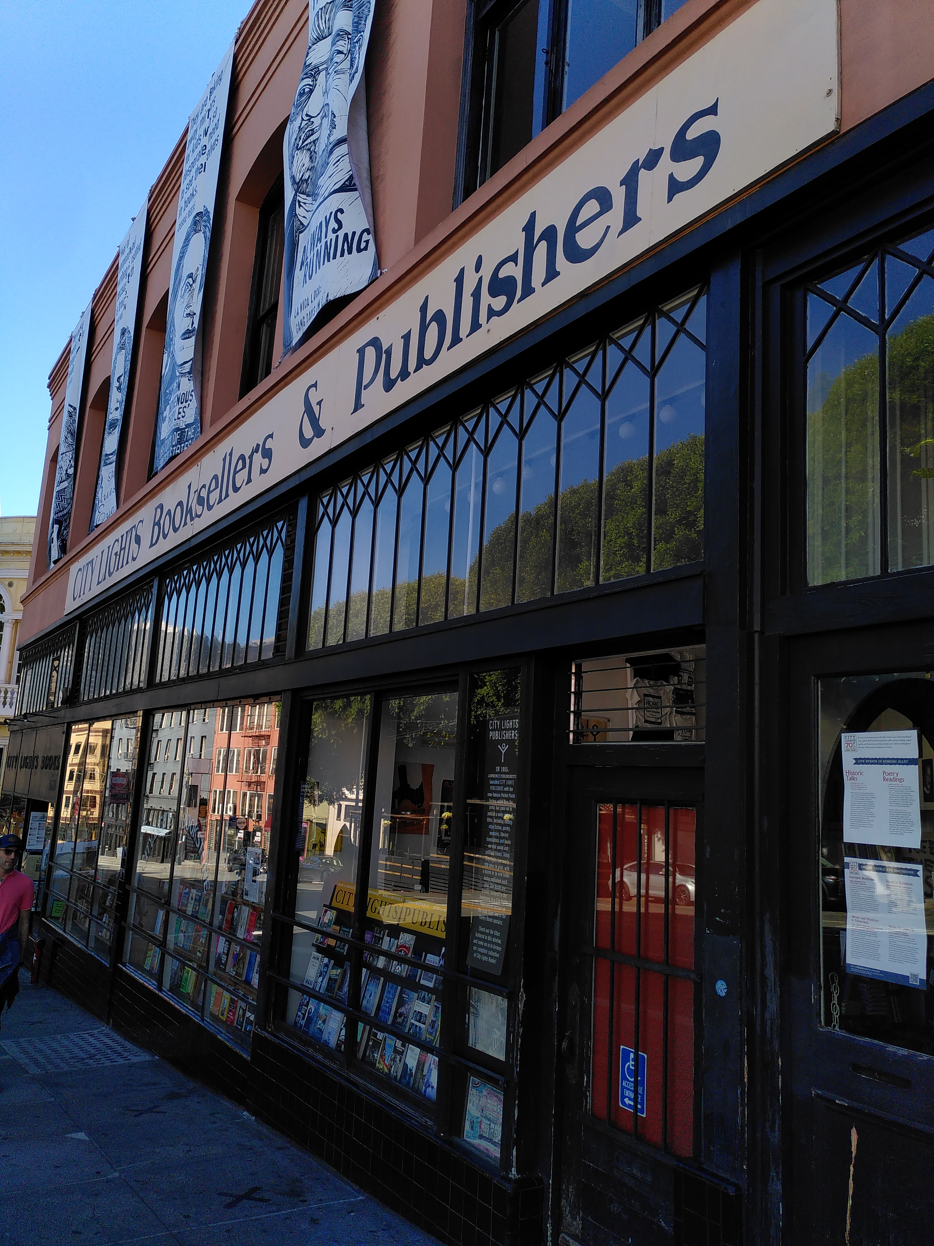 A building with a sign saying "City Lights Booksellers & publishers".